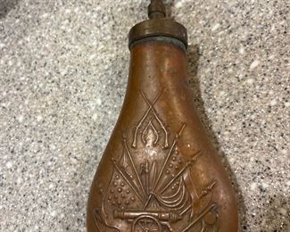  Copper and brass original 19th century embossed powder flask showing an artillery cannon scene with various US flags and cross rifles.