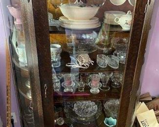 Antique curio cabinet. Crystal stemware, serving bowls, vases, vintage porcelain with rose pattern 4 piece china and soup taurine