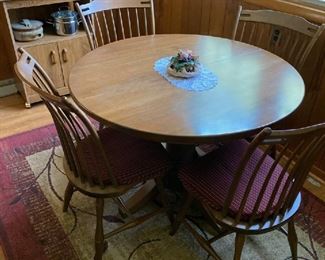 Solid maple dining set. 4 chairs, two leaves (not shown) excellent condition.  Microwave cart,  Dark red and tan area rug,  Four piece Ceramic  canister set/ blue floral pattern