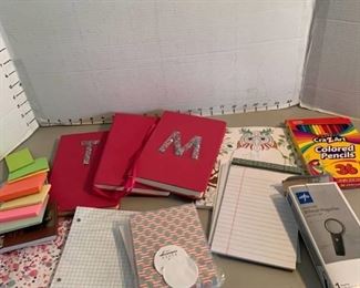 Journals and paper, pencil and magnifying glass