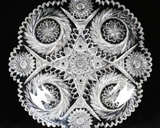         10	American Brilliant Cut Glass Plate	Brilliant cut glass plate. Hobstars, pinwheels and flowers. 11 5/8"-diameter. Chips and fleabites to rim, chips and fleabites throughout.
