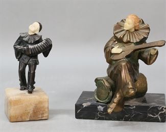         13	2 Art Deco Pierrot Figures	2 art deco pierrot  figural sculptures. Pierrot with mandolin, gilt painted metal figure with resin head and hands, on a marble base, 6"H; pierrot with accordion, on marble base, 5 3/8"H. Pierrot with mandolin minor losses and oxidation to gilt decoration, pierrot with accordion line to head, chip to corner of base, paint loss to head.
