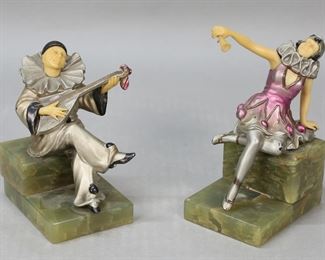         14	Pair of Art Deco Bookends Pierrot & Columbine	Pair of art deco figural bookends, pierrot and columbine. Cold painted metal with resin faces, arms and hands. On green onyx bases, bases marked Germany. Columbine 6"H, Pierrot 5"H. Columbine scratches and losses to paint, raised arm loose; pierrot scratches and losses to paint; minor chips to bases of both.
