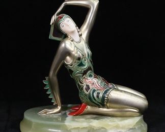         15	Chiparus Style Art Deco Dancer Figure	Art deco figural sculpture of a dancer in the style of Demetre Chiparus. Cold painted gilt bronze on onyx base. 6 7/8"H. Scratches and losses to painted decoration.
