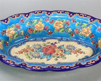         21	Emaux de Longwy Enamel Faience Serving Dish	Emaux de Longwy French enamel decorated faience porcelain oval serving bowl. Floral motif. Longwy and Made in France marks on the underside. 13 1/4"L x 2 1/2"H. Crazing throughout, discoloration to bottom half of bowl.

