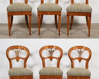         46	Six Biedermeier Dining Chairs	"Six Biedermeier dining chairs. Walnut, carved acanthus form splats, saber legs. Refinishing throughout all chairs. Splits and cracks to splats on three chairs, with repairs to carving on one chair. Loss and repairs to molding above left leg on one chair. Splitting to veneer throughout all chairs. 

17 3/8"" W x 18 1/2"" D x 35 7/8"" H. Each chair weighs 13 lbs."
