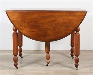         47	Victorian Drop Leaf Dining Table	"Victorian drop leaf dining table. Drop leaves, carved geometric and turned legs on casters. Three additional table leaves are provided with table, along with leather and felt table pads. Scratches and scuffs to top of table. Nicks and marks to wood on legs of table. Scratches and scuffs to wood on all table leaves. Wear and marks throughout table pads. Nicks and chips to wood on edges of table top.

Closed: 43 1/2"" W x 26 1/2"" D x 29"" H. Table becomes 53 3/8"" W with drop leaves extended. With all leaves inserted table is 95 1/4"" W."
