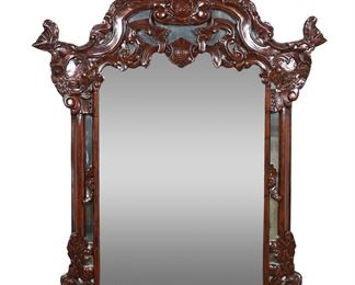         48	Rococo Revival Style Hall Mirror	"Rococo Revival style hall mirror by Design Toscano. Late 20th century. Mahogany with heavily carved floral motifs. No labels or maker's marks. Light wear and scuffs to mirror.

47"" x 55 1/2"". 45 lbs."
