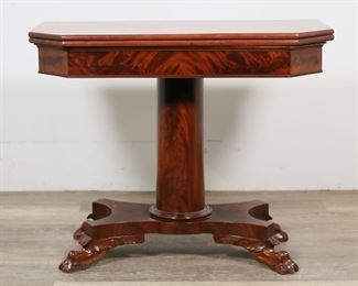         53	American Classical Mahogany Game Table	"American Classical game table. Circa first quarter of 19th century. Burled mahogany, fold-out swivel top, columnar form pedestal, carved lion's paw feet. Scratches and scuffs to top of table. Splitting to panels on interior of table. Scuffs and nicks to toes on carved paw feet. 

Closed: 35 7/8"" W  x 17 5/8"" D x 28 3/4"" H. Open and swiveled: 35 1/4"" W x 35 7/8"" D x 28"" H. 48 lbs."
