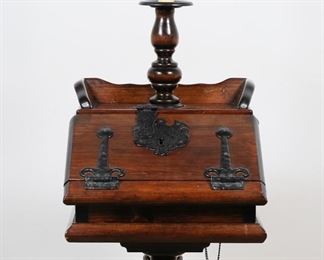         55	Jacobean Style Tavern Lamp Table	"Jacobean style tavern lamp table. 20th century. Drop-front desk form with attached iron key on chain, felt lined interior, turned legs on pedestal base. Nicks and scuffs to wood on right side of gallery on top of table. Scuffs and scratches to wood throughout base. Chip to wood on lower left corner of front of table. Shade is missing. Lighting has been tested and is in working condition. 

17 1/2"" W x 17 1/4"" 60 1/2"" H (to top of finial). 41 lbs."
