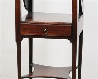         56	Georgian Mahogany Washstand	"Georgian mahogany washstand. 19th century. One drawer, lid revealing section for bowl and cups, pad feet. Wear, scratches, and nicks to wood of top, second, and third tiers. Splits to wood on storage section under lid and on left side of piece next to carved fret holes. Nicks and wear to wood on pad feet. From a prominent Connecticut collection. 

14 1/2"" W x 14 1/4"" D x 33 1/4"" H
"
