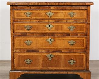         60	Queen Anne Walnut Chest of Drawers	"Queen Anne walnut chest of drawers. Circa 1710. Four graduated drawers, brushing slide, bracket feet. Later brass hardware. Wear, scratches, nicks, and scuffs to wood on top of chest. Losses to veneer on edge of top and to wood on left side next to third lowest drawer. Looseness to brass pulls on lowest drawer. Separation of lock plate from top drawer. Refinishing and restorations to top of chest. 

29 1/4"" W x 15 3/4"" D x 28 1/4"" H

Provenance: Christie's Important English Furniture, Lot 205, October 18th, 2001. From the collection of a prominent Connecticut family."
