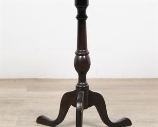         62	Federal Tilt Top Candle Stand	"Federal tilt top candle stand. American, 19th century. Tripod form legs, turned center post, marquetry inlay of urn. ""La Gerber"" (?) written in pencil on underside of top. Wear, scratches, and water damage to wood of top. Chips, scuffs, wear and losses to wood of legs. Separation of joinery from one leg to center post. 

Tilted up: 19 1/4"" W x 18 5/8"" D x 41"" H. With top tilted down: 25 3/8"" W x 16 3/8"" D x 27"" H. 

From the collection of a prominent Connecticut family."
