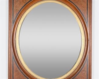         63	Aesthetic Movement Eastlake Style Mirror	"Aesthetic Movement mirror with East Lake style motifs. 20th century. Carved wooden frame with incised and gilded motifs surrounding oval mirror with gilded inner edge. Losses to gilt throughout inner edge of mirror. Partial separations to joinery of frame on corners. Chips and loss to wood on one corner of frame. Mirror is slightly loose in frame.

30 1/8"" x 26"". 16 lbs."
