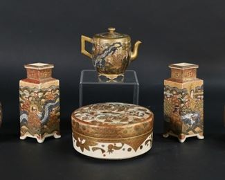         67	6 Pieces Satsuma Japanese Porcelain	"6 pieces Satsuma Japanese porcelain. Pair of vases with immortals and applied dragons, Choshuzan style marks, each 7 1/8""H; pair of diamond form cabinet vases, each 5 3/8""H; lidded box with woman and daily life scenes, 2 1/2""H x 5 1/2""-diameter; lidded teapot, 3 5/8""H. All with some crazing and losses and scratches to decoration; dragon vases minor chips and roughness to dragon heads, diamond vases repairs to rims, lidded box chips to interior rim of lid. 
"
