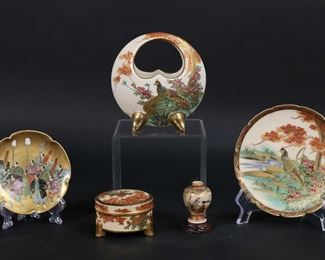         69	5 Pieces Satsuma Japanese Porcelain	5 pieces Satsuma Japanese porcelain. Moon basket / vase and dish, both with bird motifs and Hododa Satsuma marks, vase 4 1/2"H, dish 4 7/8"-diameter; lidded box, Taniguchi mark, 1 1/2"H x 2 1/2"-diameter; dish, Kyokuzan mark, 3 3/4"-diameter; miniature cabinet vase, Kusube mark, 1 3/4"H. All with some crazing and minor losses to decoration.
