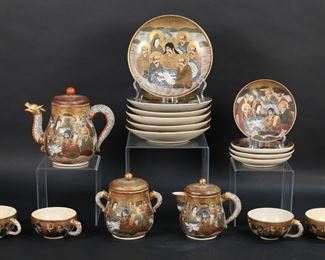         70	Satsuma Hododa Porcelain Tea Set	17 pieces Satsuma Japanese porcelain. 11 piece tea set with teapot, lidded sugar bowl and creamer, and 4 cups and saucers, all with dragon handles and dragon spout on teapot, all with Hododa Satsuma marks, teapot 6 5/8"H. With 6 associated Satsuma plates, each 7 1/8"-diameter. Crazing, minor losses and scratches to decoration on all; flake to rim of one cup.
