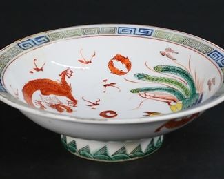         73	Chinese Export Porcelain Dragon & Phoenix Bowl	Chinese export porcelain pedestal bowl. With dragon and phoenix motif and Greek key decoration on rim. Red six character mark on the underside. 2 5/8"H x 8 1/4"-diameter. Repair to rim, paint loss to decoration throughout.
