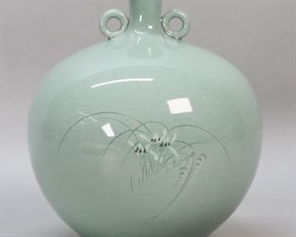         72	Korean Celadon Porcelain Vase	Korean celadon 2 handled porcelain vase. Crackle glaze, decoration of flowers and grasses. Signed on the underside. 7"H.
