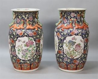         74	Pair of Qianlong Chinese Porcelain Vases	Pair of Chinese porcelain vases. Cobalt and iron red with flower and butterfly decoration and dragon and caterpillar handles. Both with red Qianlong style marks to the underside. Each 14 1/4"H. Both drilled, one with chip to underside, scratches and wear around rims of both, discoloration and scratches to interiors of both.
