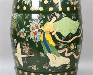         79	Chinese Figural Garden Seat	"Chinese figural garden seat. 20th  century. Dark green porcelain garden seat decorated with cranes and women. Unmarked. Light scuffs, scratch, and wear to top of garden seat. Paint and glaze loss to section of vent hole on top.

18 1/4"" H x 11 1/2"" diameter of top. 17 lbs."
