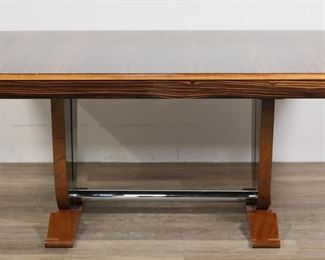       110	Camard French Art Deco Dining Table	"French Art Deco dining table produced by Camard. 20th century. High-gloss finish, zebrawood top, trestle form with chrome stretcher, two pullout storage drawers on either side. Camard ""Made in France"" label on inside of one drawer. Wear, scuffs and light scratches to finish and wood of top. Chips and wear to wood on feet of table. Light scratches and scuffs to chrome. 

63 1/8"" W x 39"" D x 29 3/4"" H."

