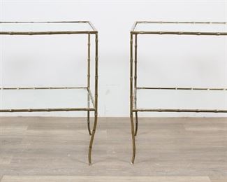        117	Pair of Hollywood Regency Faux Bamboo Side Tables	"Pair of Hollywood Regency side tables in the style of Maison Bagues. 20th century. Inset glass tops with lower tiers on bamboo form brass tables. No apparent maker's marks or labels. Chips and fleabites to glass on edges of both tops and one tier. Scuffs, scratches, and wear to glass of both tables. Wear and tarnishing to brass on both tables. Bending and warping to brass on two legs on each table.

24 1/2"" W x 20 1/4"" D x 25"" H. Each table weighs 34 lbs."
