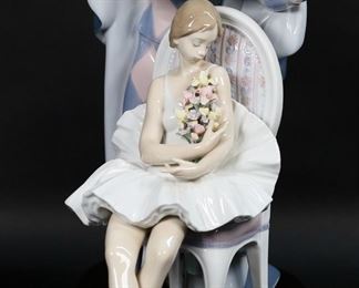        129	Lladro Porcelain Figure Group Jester's Serenade	Lladro porcelain figure group 5932, Jester's Serenade. Blue Lladro mark and artist signed Ramos and Ruiz on the underside. Number 2130 from the limited edition of 3000. On wooden base. Figure 14 1/2"H x 14"L not including base. Scratches to wooden base.
