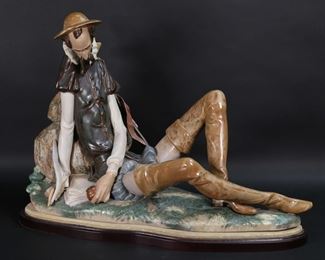        141	Lladro Porcelain Figure Letters to Dulcinea	Lladro porcelain figure 3509, Don Quixote: Cartas a Dulcinea (Letters to Dulcinea). Artist signed Salvador Debon and Julio Ruiz, with blue Lladro mark on the rock base. Number 383, with certificate, circa 1979. On wooden base. Figure 21"L x 14"H not including wooden base. Hilt of sword loose, with apparent repair; wear and discoloration to fabric on base.

