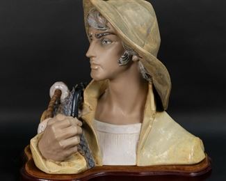        143	Lladro Porcelain Fisherman Bust	Lladro porcelain bust 2108, Fisherman. Blue Lladro mark to the underside. On wooden base. 14"H x 14 1/4" not including base.

