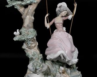        146	Lladro Porcelain Figure Swinging	Lladro porcelain figure 1297, Swinging. Blue Lladro mark to the underside. 14 7/8"H x 11 1/4"W.

