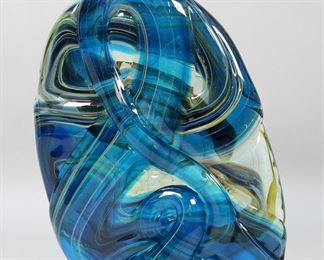        170	Michael Harris Mdina Art Glass Sculpture	Mdina Glass, Michael Harris, Malta. Abstract art glass sculpture, blue with green and yellow swirls. Signed and dated 1973 on the underside. Chips to both sides of the base.
