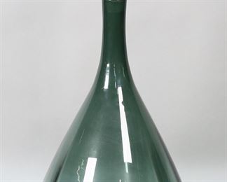        176	Blenko Art Glass Decanter	Large vintage Blenko art glass decanter or bottle. Green glass, stopper with air twist. Unsigned. 20 7/8"H, 10 1/4"-diameter at base. Chips and roughness to interior end of stopper, scratches to underside of bottle, some discoloration to inside. Mid century modern art glass,

