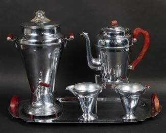        178	Mid-Century Chrome & Bakelite Coffee Set	5 associated mid-century modern chrome plated coffee serving pieces. Everbrite electric coffee urn with Bakelite handles and glass finial, teapot with Bakelite handle and finial, matching sugar and creamer with Bakelite handles, serving tray with Bakelite handles. Tray 19 3/4"L, urn 13"H. Tarnish, discoloration and minor losses to chrome on all, scratches to Bakelite, urn missing plug and untested.
