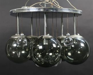        184	Lightolier Modern Chrome 5 Light Chandelier	Lightolier mid-century modern flush mount ceiling fixture. Chrome, with 5 smoked glass globes and 10 hanging glass ball drops. Lightolier paper label. 9 1/4" from cap to bottom of globes, cap 15"-diameter. Minor chips, flakes and roughness to rims of shades, losses and scratches to patina on chrome.
