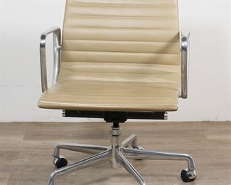        204	Eames for Herman Miller Aluminum Group Chair	"Charles Eames (American, Missouri, 1907-1978) and Ray Eames (American, California, 1912-1988) for Herman Miller. Aluminum Group office chair. 21st century. Aluminum arms and frame supporting tan leather seat. Herman Miller barcode labels on underside of chair. Wear and fading to leather on seat of chair. Scuffs and losses to leather on bottom left and right corners of seat. Scratches, scuffs and wear throughout aluminum. 

22 1/4"" W x 22 5/8"" D x 32"" H. Spoke base on casters measures 24 1/2"" W. Seat height 17 1/8"" H, arm height 25 1/4"" H. 32 lbs."
