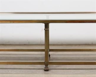        211	Mastercraft Style Mid Century  Cocktail Table	"Mid Century Modern cocktail table in the style of Mastercraft. 20th century. Brass table with rectangular form legs and stretcher and beveled glass top. Staining, wear, and tarnishing throughout brass of table. Small chip to one corner of glass.

56"" W x 22"" D x 16 1/8"" H. 67 lbs."
