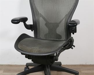        213	Herman Miller Aeron Office Chair	"Don Chadwick (American, born 1936) and Bill Stumpf (American, 1936-2006) for Herman Miller. Black molded plastic and metal with lumbar support and height, tilt, seat, and arm adjustments. Herman Miller molded label on back of chair. White scuffs and wear to back of arms and adjustment controls. Break and cracking to plastic lumbar support piece on back of chair. 

27 3/8"" W x 22 1/2"" D x 43 1/2"" H at tallest height. 39"" tall at shortest height. 47 lbs."
