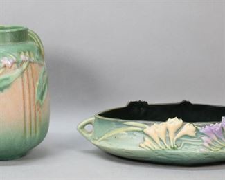        257	Roseville Laurel Green Vase & Freesia Bowl	2 pieces Roseville pottery. Laurel Green pattern vase, 8 3/8"H; Freesia pattern console bowl, 13 1/2"L including handles. Laurel Green vase unsigned. Vase chip to underside, bowl chips and roughness to flowers on one side.

