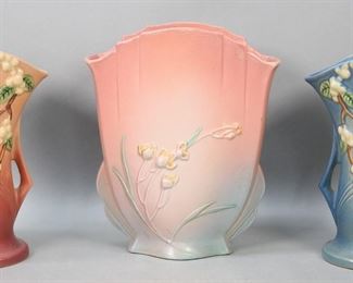        260	3 Roseville Pottery Vases Snowberry & Ixia	3 Roseville pottery vases. 2 Snowberry pattern vases, in pink and blue, IV2-9, both signed Roseville U.S.A., each 9 1/2"H; Ixia pattern pillow vase, in pink, 863-10, signed Roseville, with additional Roseville Pottery paper label, 10 1/2"H. Some crazing to all.
