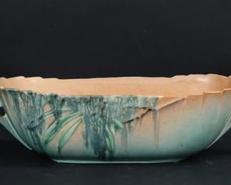        261	Roseville Moss 3 Piece Console Set	Roseville pottery Moss pattern console set. Oval bowl, 14 1/2"L including handles; and a pair of three arm candlesticks, each 6 7/8"H. 2 flakes to rim of bowl, wax residue to candlesticks, crazing to all.
