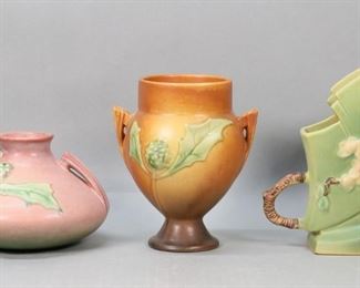        262	5 Roseville Pottery Vases	5 Roseville pottery vases. Apple Blossom pattern vase with twig handles, 7 1/4"H; Thornapple pink vase, 4 1/4"H; Thornapple brown vase, 6 3/8"H; Magnolia vase, 7 3/8"H; Poppy vase, 3 3/4"H. Crazing to all, some discoloration to Poppy vase.
