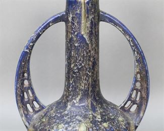        269	Julius Dressler Austrian 2 Handled Vase	Julius Dressler Austrian pottery vase. Two reticulated handles, green and blue textured glaze. Incised mark on the underside 1280 Austria. 10 3/4"H. Glaze misses along the rim.
