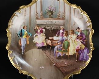        273	Limoges Hand Painted Charger Interior Scene	Hand painted Limoges porcelain charger. Parlor scene, signed along the rim lower right Dubois, with gilt painted rim. Red L.S. & S. Limoges France mark to the underside (Lewis Straus & Son). 15 3/8"-diameter. Minor scratches and losses to gilt decoration on rim.
