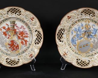        286	Pair of KPM Porcelain Armorial Plates	Pair of KPM porcelain plates. Hand painted heraldic motifs with silver tone, gilt and enamel decoration and reticulated rims. Each with red KPM orb and cross marks with blue painted scepter above, impressed numbers. Each 9"-diameter.
