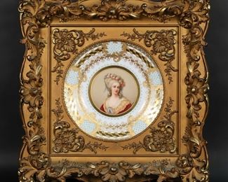        287	Royal Vienna Style Cabinet Plate Lamballe	Royal Vienna style porcelain cabinet portrait plate. Portrait of Marie Therese Louise, Princesse de Lamballe, signed Wagner. With turquoise enamel and gilt decoration. Titled, with "beehive" mark to the reverse. 9 1/2"-diameter, with frame 17" x 17". Splits and minor losses to gilt frame.
