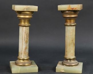       290	Pair of Onyx & Brass Pedestals	Pair of onyx and brass columns / pedestals. Taller 10 1/4"H x 3 7/8"W x 3 7/8"D at base. Losses to patina on brass, chips to edges of both, taller repaired at base of column and underside.
