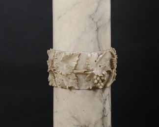        293	Neoclassical Style Marble Column Pedestal	"Neoclassical style marble column pedestal or sculpture plinth. Doric form column in veined white marble adorned with grape and vine motif around center of shaft. Column separates into five pieces. Scratches and heavy scuffs to top of pedestal. Loss to marble on second band on shaft from top. Large scuffs and scratches throughout lower half of shaft and throughout base. Large loss to marble on bottom of shaft. Chips and losses to marble throughout octagonal base. Chips and losses to leaves around center of shaft.

Base measures 13 3/4"" W x 13 3/4"" D. 41 5/8"" H x 12"" diameter of top. 97 lbs."
