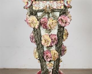        301	Italian Majolica Porcelain Floral Pedestal	"Italian Majolica porcelain pedestal or sculpture plinth.  Adorned with porcelain flowers, and garland with spiraling motifs. Unmarked. Minor chips and losses on edges of flowers. 

15 1/8"" W x 15"" D x 38 7/8"" H. 63 lbs."

