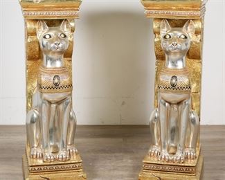        303	Pair of Egyptian Revival Style Bastet Pedestals	"Pair of Egyptian Revival style Bastet Pedestals by Design Toscano. 20th century. Gilded and silver tone composite pedestals each supported by a figure of Bastet, the ancient Egyptian cat goddess. Scuffs, marks and wear to tops of pedestals. 

12"" W x 14"" D x 37 3/4"" H. Each pedestal weighs 22 lbs. 
"
